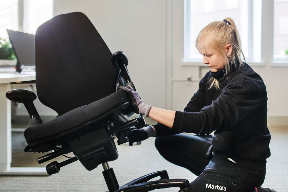 A woman is assembling an office chair.