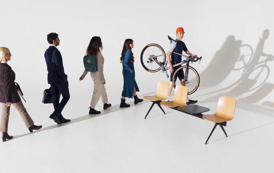 People walking in a line around Sola Beam chair