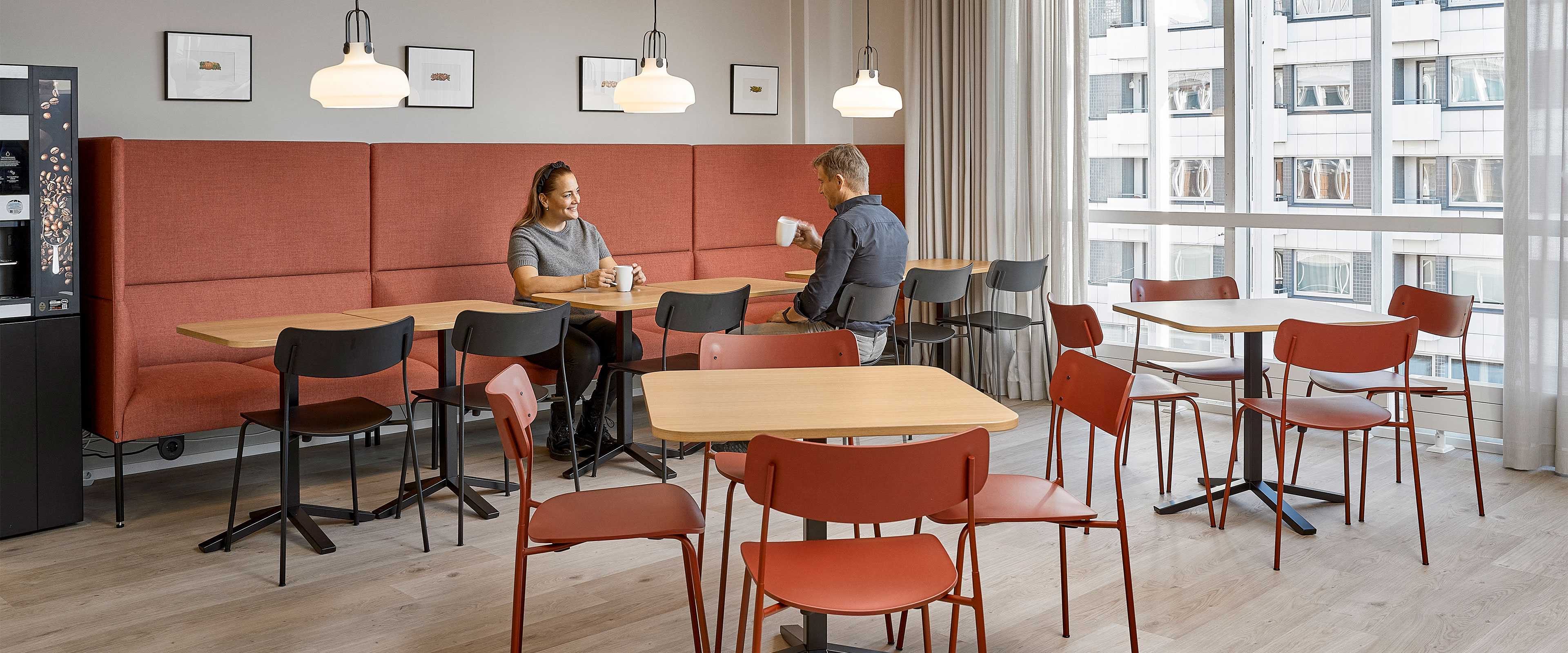 Two people having coffee in Orkla Finland's working cafe